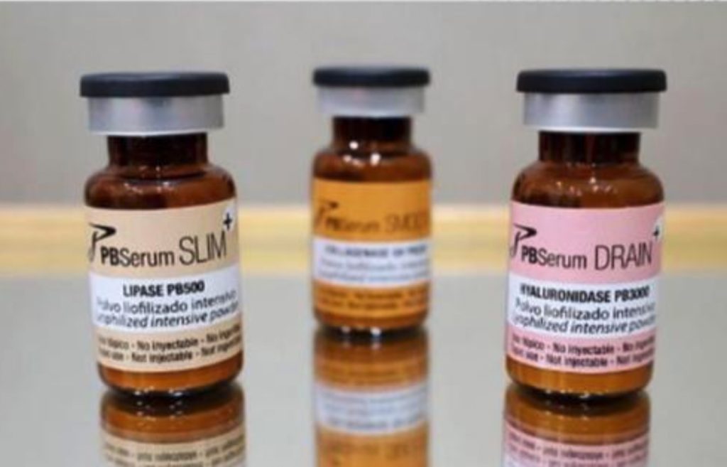 Close-up photo of PBSerum Slim, Drain, and DNA vials used for non-invasive fat reduction, skin tightening, and cellulite treatment at VIVE Medical Spa Tijuana