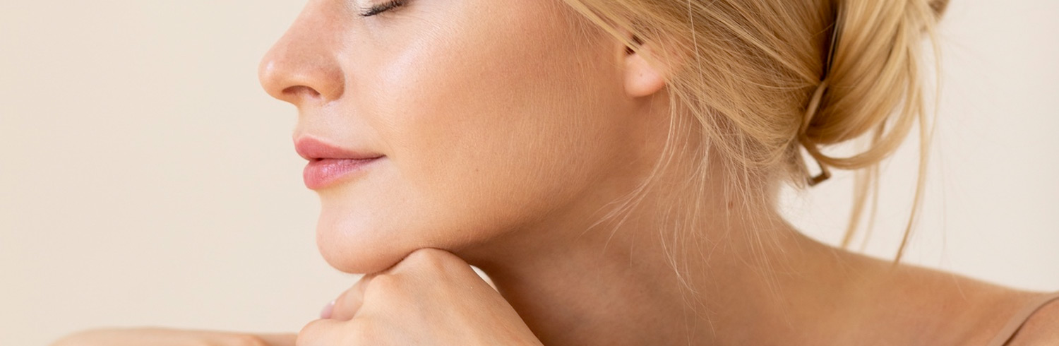 Side profile of a blonde woman with smooth skin showing chin and nose shape