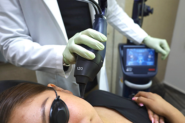 Patient receiving advanced facial laser rejuvenation with specialized equipment at VIVE Medical Spa Tijuana